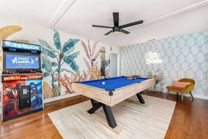 Game room with pool table and Supercade machine. 
