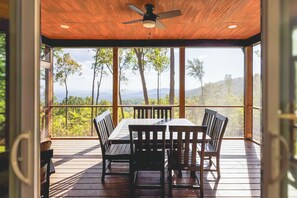 Enter the screened-in room on the porch to enjoy dining al fresco without worrying about bugs and weather.