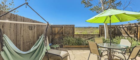 Private back patio with sun lounger and outdoor dining