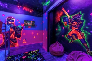 Create lasting memories in this vibrant room filled with cosmic charm and fun.
