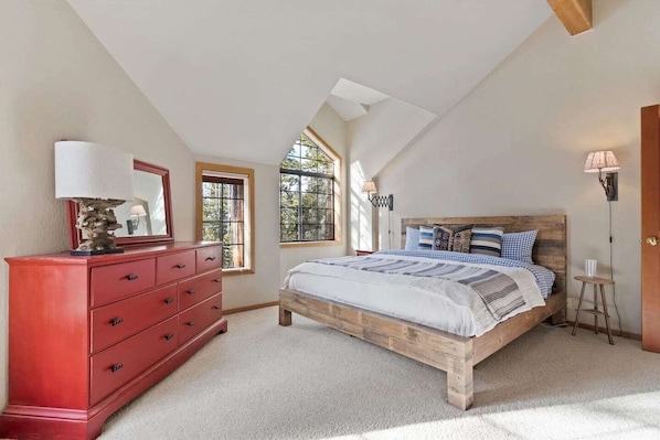 Primary bedroom with kings sized bed upstairs.