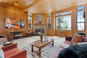 The living room with breathtaking views of Marti's Valley and a gas fireplace.