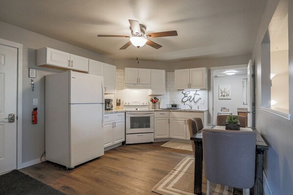 Fully equipped kitchen with stainless steel appliances, perfect for cooking homemade meals during your stay. Enjoy the convenience of a coffee maker, microwave, and a large refrigerator.