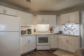 Fully equipped kitchen with stainless steel appliances, perfect for cooking homemade meals during your stay. Enjoy the convenience of a coffee maker, microwave, and a large refrigerator.