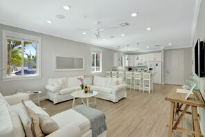 All Villas living room | Windows galore, white and bright coastal design + comfy ample seating.