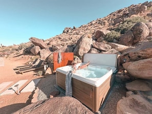 Nestled in front of the boulders is our saltwater hot tub with 19 jets.