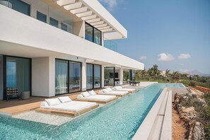 A private, L-shaped, 25-meter-long, ecological saltwater swimming pool, which uses saltwater electrolysis