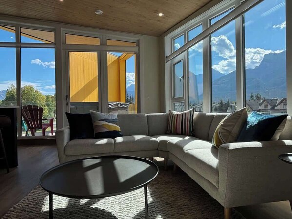 Gorgeous views from East to West from this stunning top floor living room. Relax by the fireplace, or hang out on the deck in your private hot tub. 