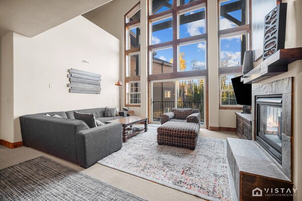 The main living space features an open layout with a cozy gas fireplace, perfect for gathering around after a day of adventure.