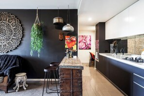 Cook in style in this sleek, fully equipped kitchen, featuring modern appliances. Perfect for preparing meals with ease and enjoying the comforts of home.

