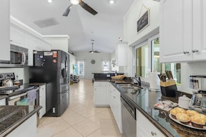 This kitchen has it all! Pass through a cold one!