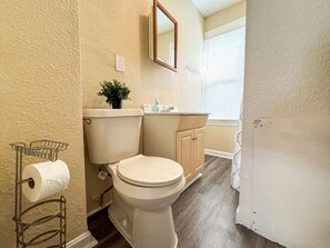 The bathroom is designed for comfort, with a spacious shower and elegant fixtures that make every moment feel luxurious.