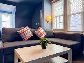 You feel at home as you settle into the living room, where the inviting atmosphere is perfect for lounging or entertaining.