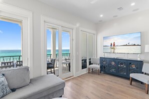 Living Room with a large comfortable sectional, Gulf views, and a HUGE 75” Smart TV - watch the big game with a view!
