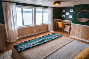 The primary bedroom is on the second floor with a king bed and water views.