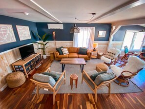 Spacious living room with plenty of seating and room for games and conversation.