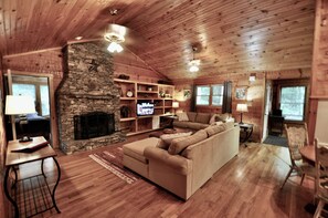 Enjoy evenings by the stacked stone wood burning fireplace .