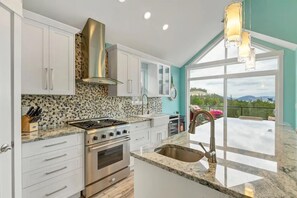 Kitchen with a views of the Pool areas and Lake Okanagan