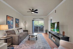 Natural light from the private balcony fills the open living room space.