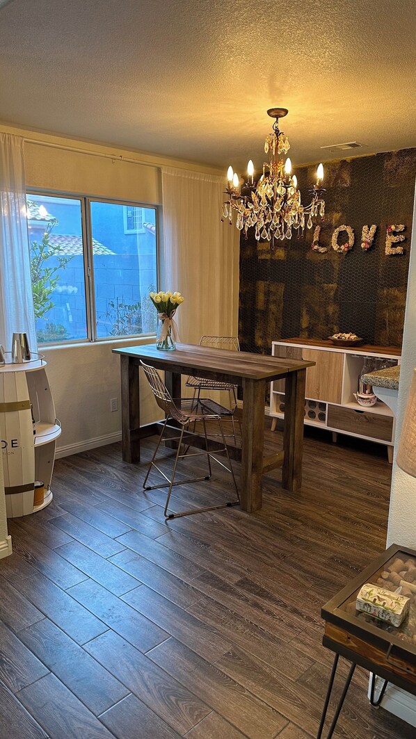 Dinning room with table and 2 tall chairs