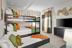 Ideal for families or groups, this room offers a full-size bed over a full-size bunk bed, with a twin trundle pull-out, plus a flat-screen Roku TV and a dresser for extra storage.