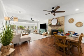 A bright, open living and dining room with seamless outdoor access, creating a spacious and airy flow between the indoors and the patio!