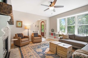 Enter the roomy and welcoming living room, situated just off the entryway. This cozy space offers plenty of seating, great for lively conversations and fostering connections