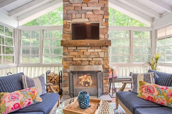 Enjoy the outdoor sunroom with a  wood-burning fireplace