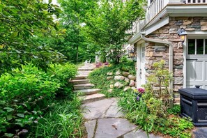 A stairway plush with nature to guide you from the driveway into the home 