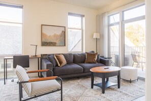 Living room with dedicated workspace and private balcony