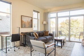 Living room with dedicated workspace and private balcony