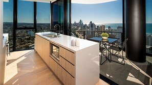 The kitchen exudes contemporary elegance with reconstituted stone benchtops and high-quality appliances.