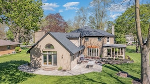 Back yard with firepit and outdoor table seating for 8