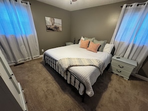 Master bedroom with king size bed and a privet full bathroom and smart tv.