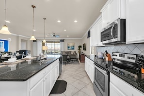 Minimalist design with stainless steel appliances, quartz countertops, and ample storage space