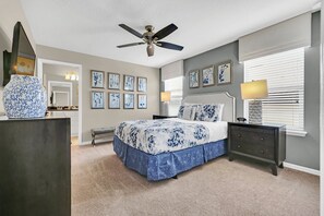 Stylish bedroom with grey and white bedding, teal accent wall, and geometric decor for a luxurious feel.