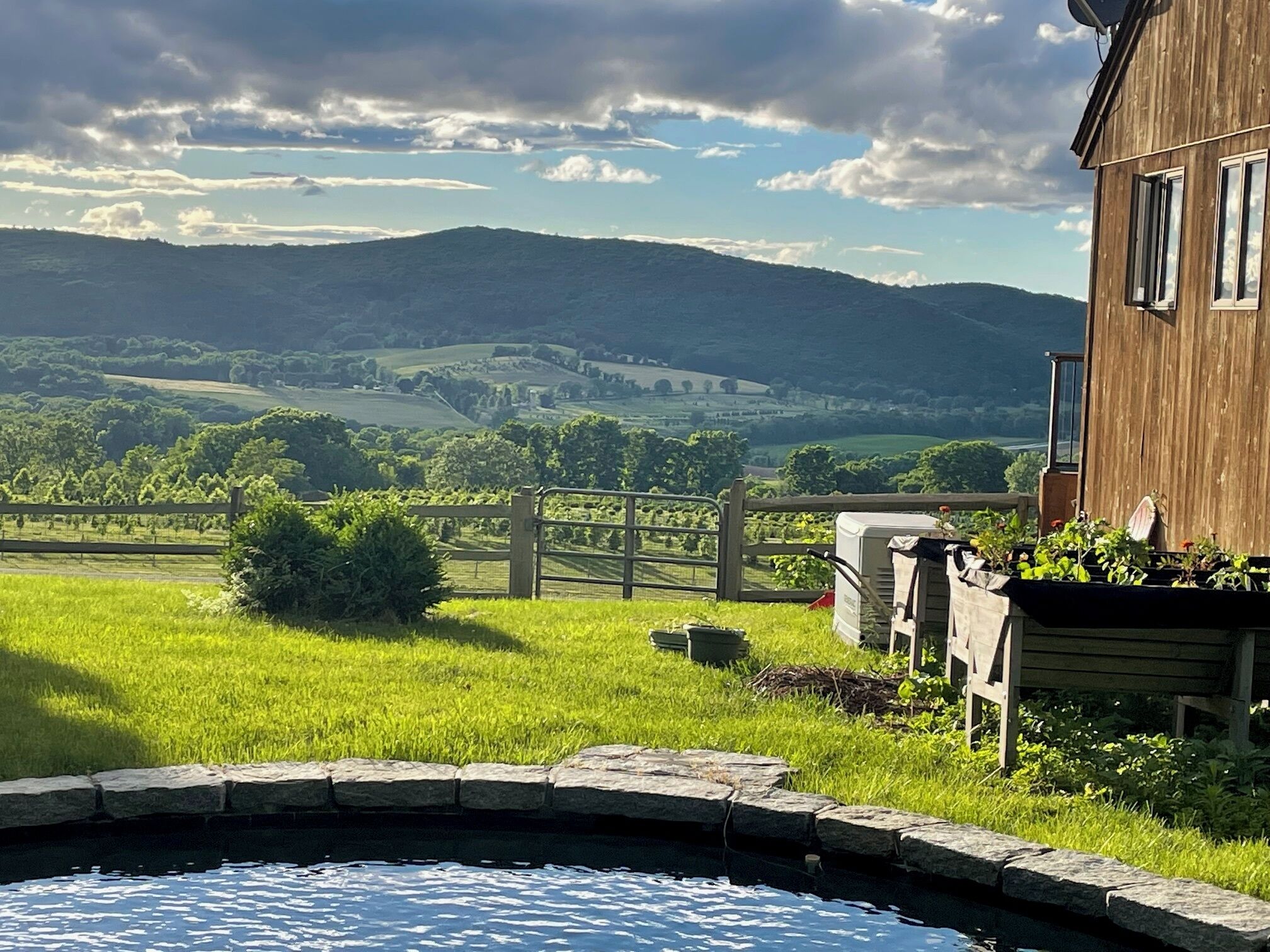 View across valley from pool with distant Catskills (30+ miles) just visible