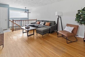 Living room with 65” Smart TV and soft throw blankets