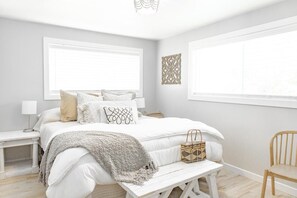 Master Bedroom with a California King Bed with 4 sleeping pillows, blk out blind