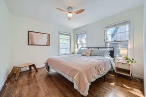 Romantic bedroom with elegant lighting and soft, neutral tones.