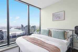 A bedroom with a queen sized bed with an en-suite.