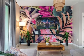 Step into paradise in our tropical-themed living room with a large smart TV!