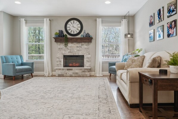 Main floor living room has 3-person couch, 2-person loveseat, 2x accent chairs