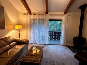 Gas wood stove and a new smart TV (just out of frame) with comfy leather seating