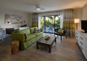 Spacious living area featuring a sleeper sofa. Balcony with resort pool view.