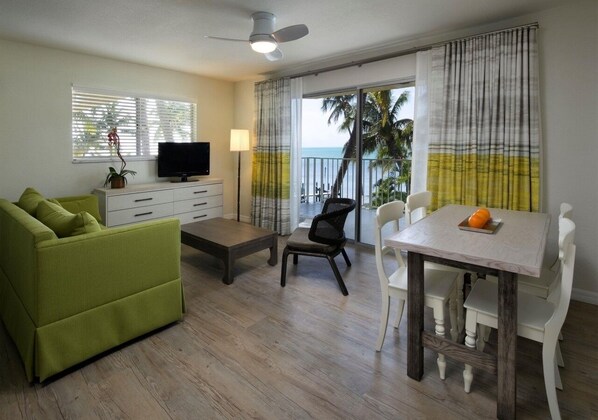 Enjoy serene tropical views from your balcony. Living area with sleeper sofa.