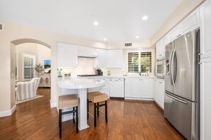 Kitchen with island, bar stools and upgraded appliances