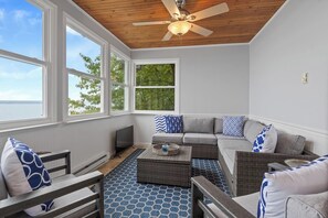 Relax in the cozy sunroom with stunning lake views. This bright and airy space is perfect for unwinding with a cup of coffee, enjoying the calm surroundings, or soaking in the sunset. ️☕
