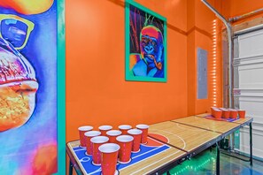 A playful oasis filled with bright orange hues and exciting entertainment options, from pool, airhockey, beerpong and foosball to arcade classics, making this the ultimate spot to unwind and have fun.