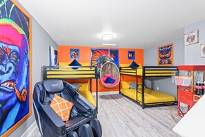 Bedroom 4 offers 4 cozy bunk beds, striking artwork, a relaxing massage chair, and a popcorn machine—perfect for a playful and relaxing stay!